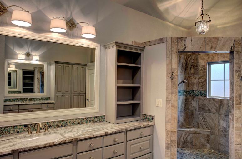 The master bathroom features customized gray paint color for raised panel cabinets.