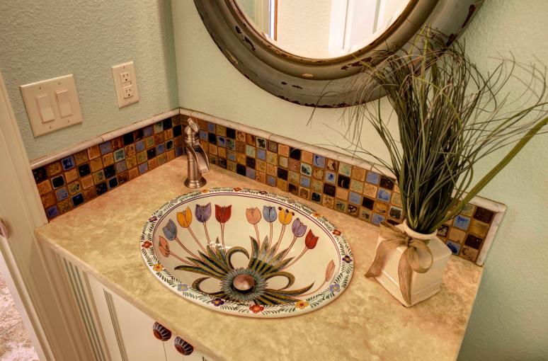 Custom painted and designed vanity with imported talavera sink.